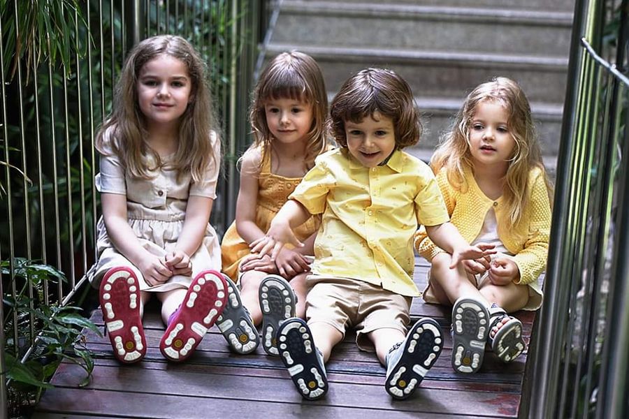 Happy children in stylish and beautiful orthopedic shoes